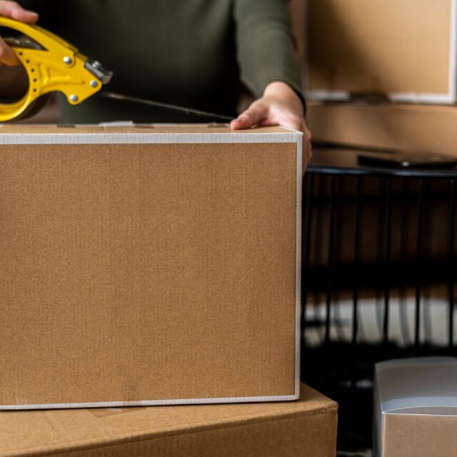 small business owner packing product parcel boxes delivery